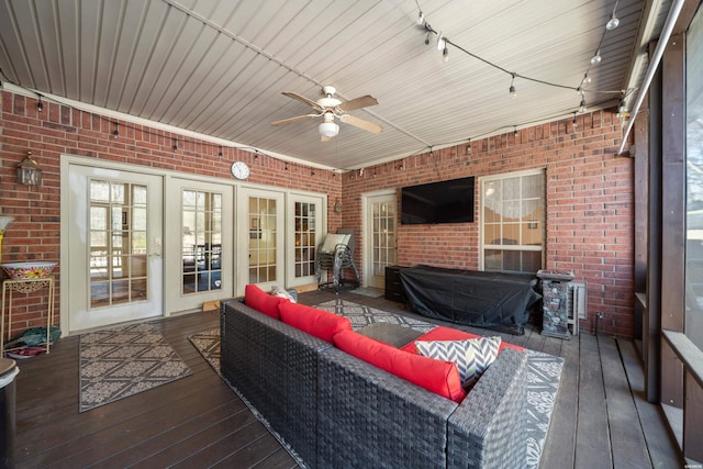 wooden terrace with french doors, outdoor lounge area, and a ceiling fan