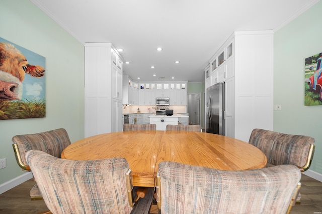 dining area with crown molding, recessed lighting, dark wood finished floors, and baseboards