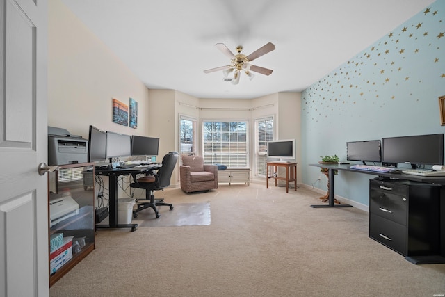 carpeted home office featuring baseboards, ceiling fan, and wallpapered walls