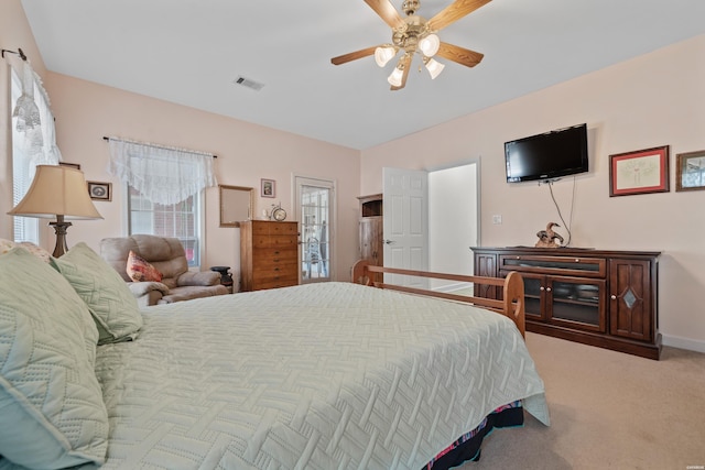 carpeted bedroom with ceiling fan, visible vents, and baseboards