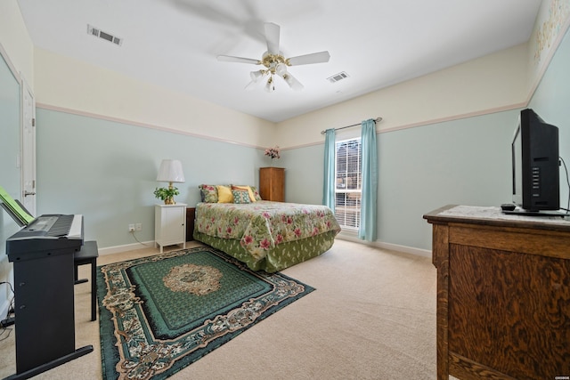 bedroom featuring visible vents, light carpet, and baseboards