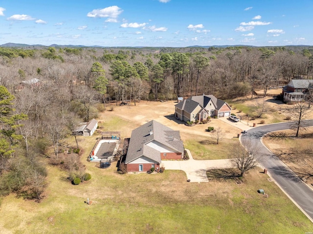 drone / aerial view featuring a view of trees