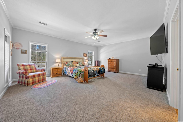 carpeted bedroom featuring baseboards, a ceiling fan, visible vents, and crown molding