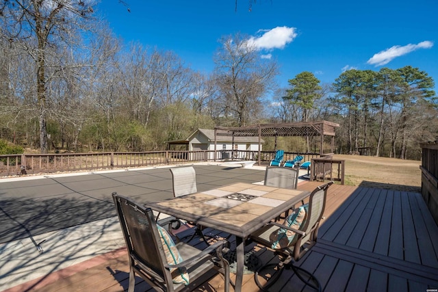 deck with outdoor dining space and an outdoor structure