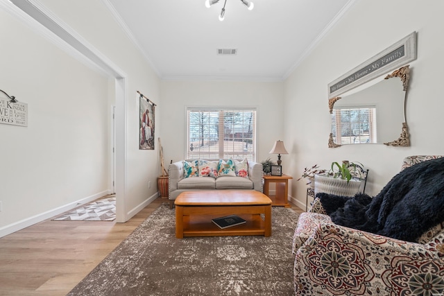 sitting room featuring a healthy amount of sunlight, visible vents, crown molding, and wood finished floors