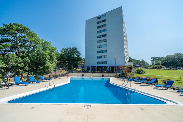 pool with fence and a patio area