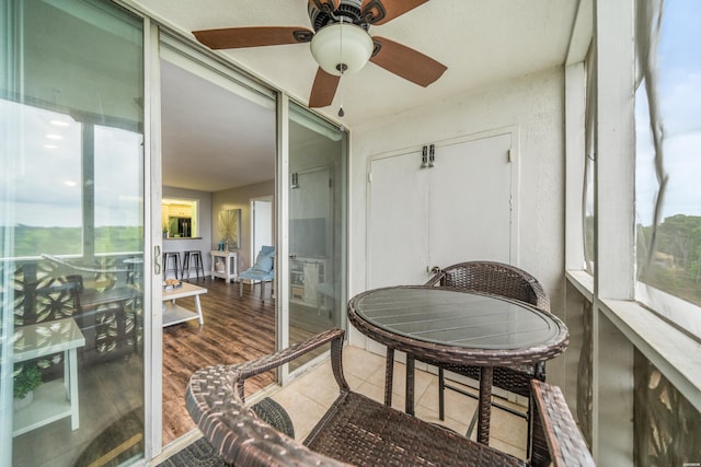 sunroom / solarium with a wealth of natural light and a ceiling fan