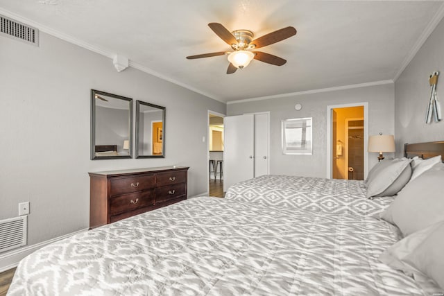 bedroom featuring crown molding, visible vents, and ensuite bath