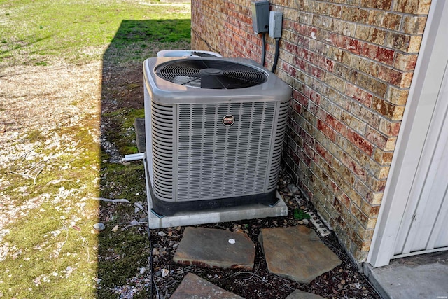 exterior details with brick siding and central air condition unit