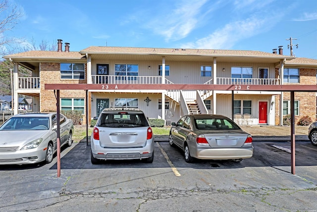 view of building exterior with uncovered parking