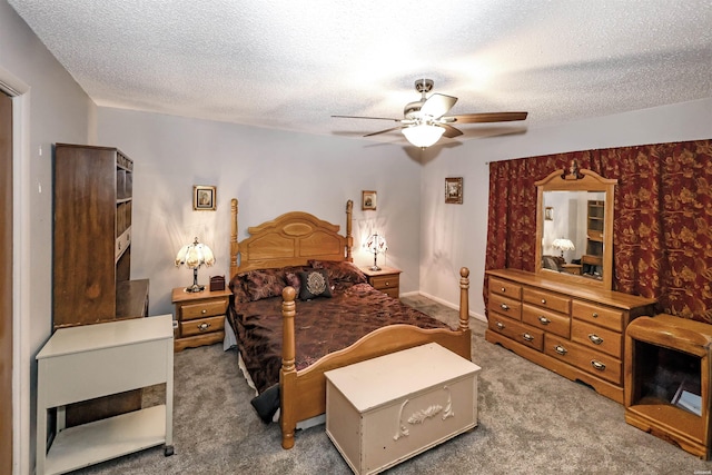 bedroom featuring baseboards, ceiling fan, a textured ceiling, and carpet