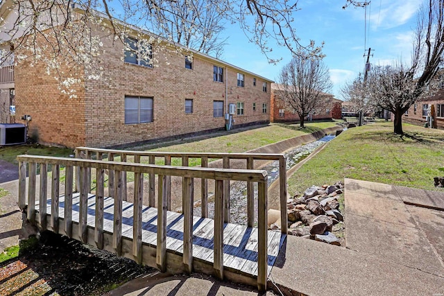 exterior space featuring central AC and a yard