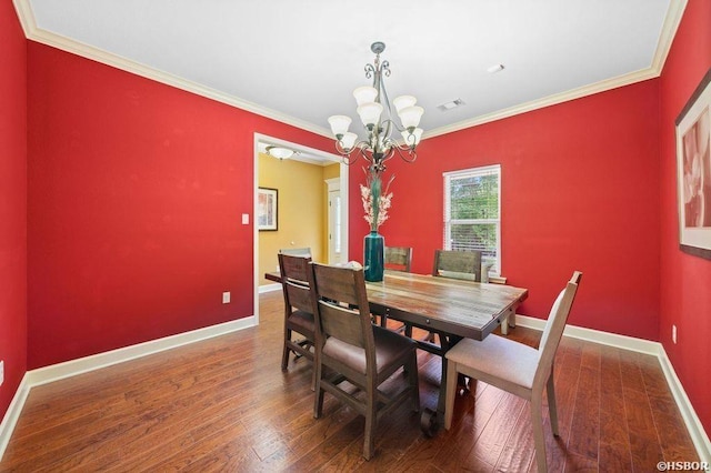 dining space featuring baseboards, dark wood finished floors, visible vents, and crown molding