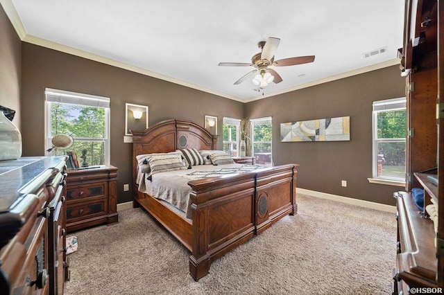 bedroom with multiple windows, visible vents, and light colored carpet