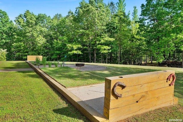 view of home's community featuring a fire pit and a lawn