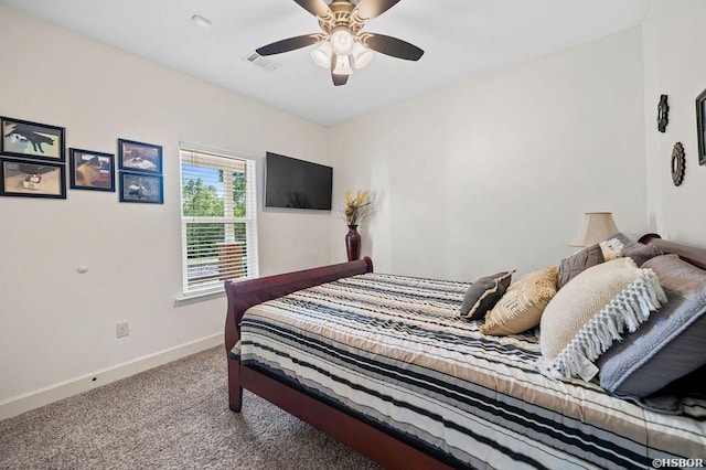 carpeted bedroom featuring a ceiling fan, visible vents, and baseboards