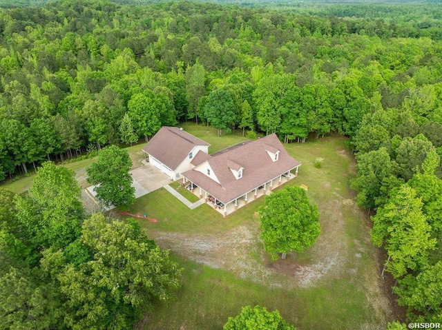 birds eye view of property with a forest view