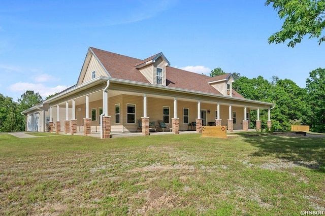 rear view of house featuring covered porch and a lawn