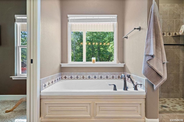 full bathroom featuring a garden tub and tiled shower