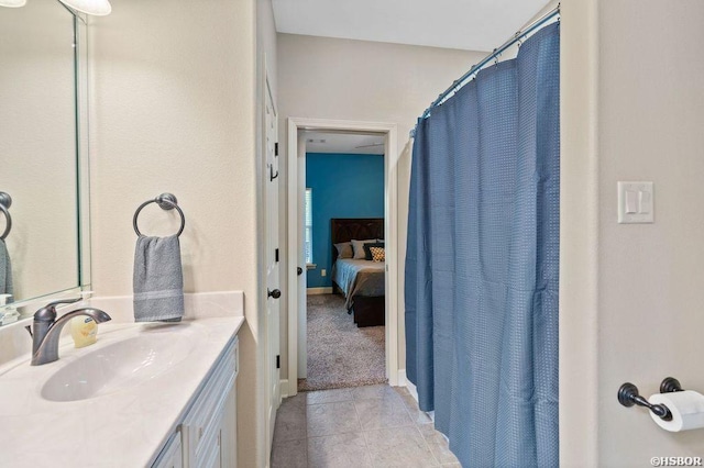 ensuite bathroom featuring connected bathroom, vanity, and tile patterned floors