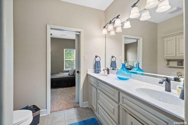 ensuite bathroom with double vanity, visible vents, a sink, ensuite bath, and tile patterned floors