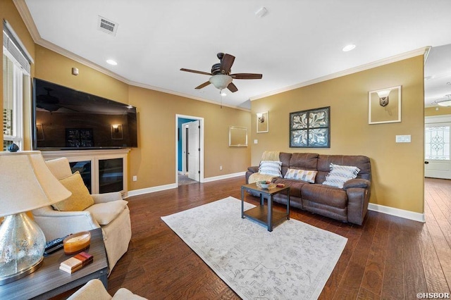 living area with ornamental molding, visible vents, baseboards, and dark wood-style floors