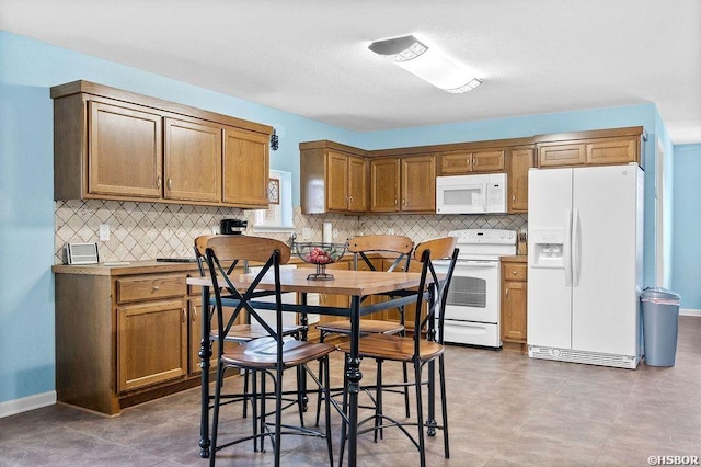 kitchen featuring white appliances, brown cabinets, and backsplash