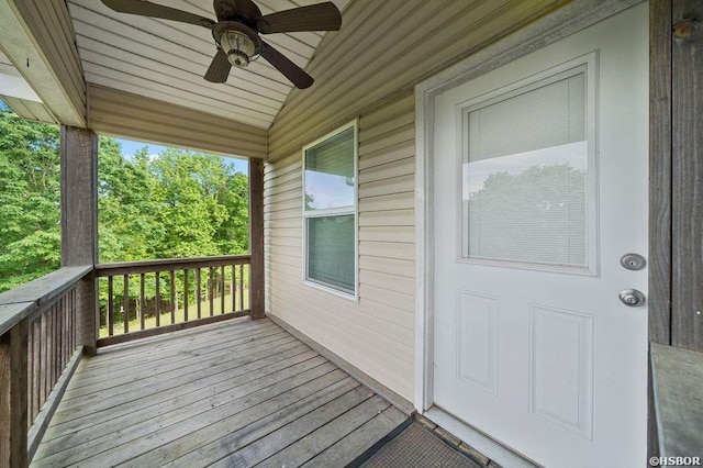 wooden terrace featuring a ceiling fan