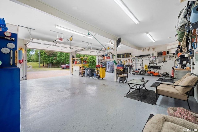 garage with a garage door opener and a workshop area