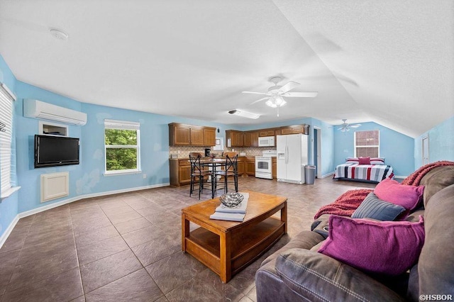 living area with a wall unit AC, ceiling fan, baseboards, and vaulted ceiling