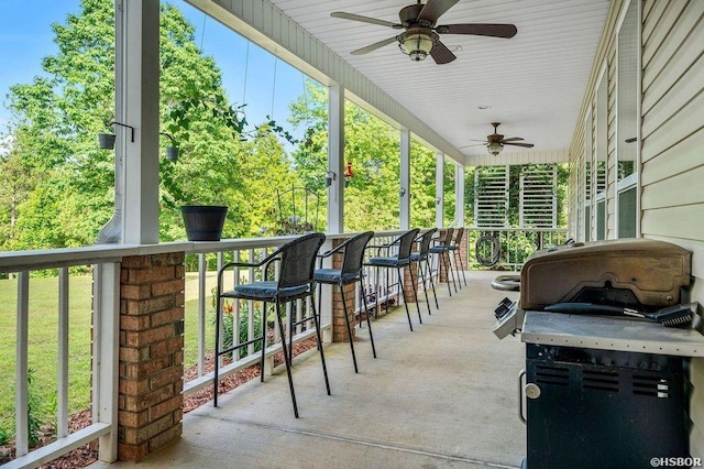 view of patio featuring a ceiling fan and outdoor dry bar