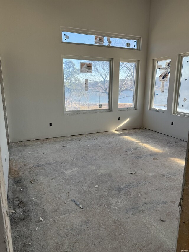 unfurnished room featuring a high ceiling