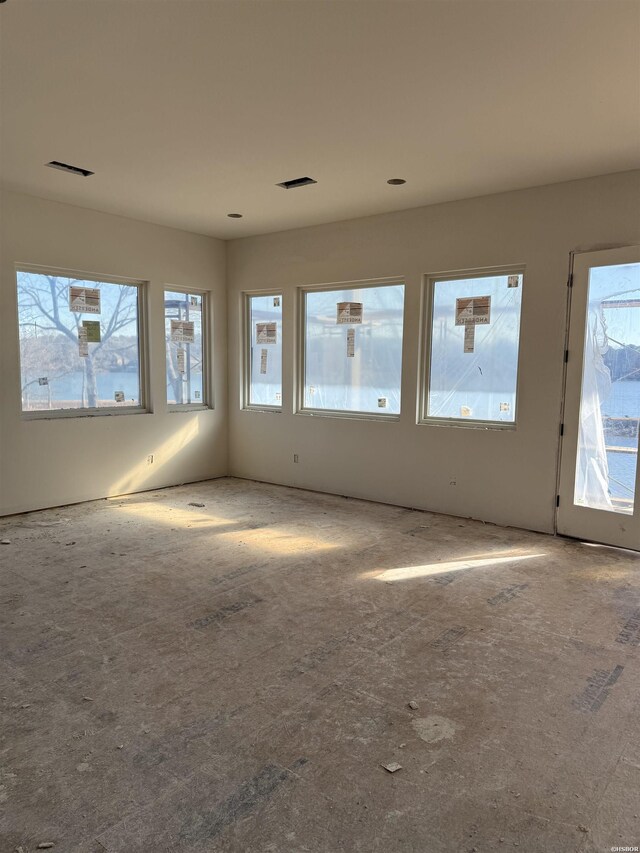 empty room featuring a healthy amount of sunlight and visible vents