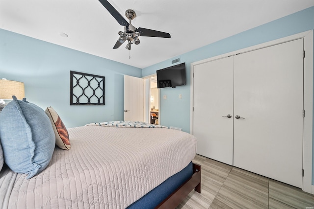 bedroom with a closet, visible vents, and ceiling fan