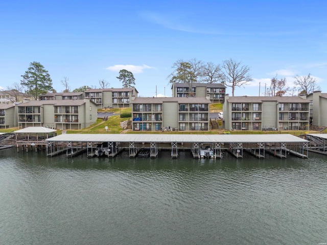 back of property featuring a water view