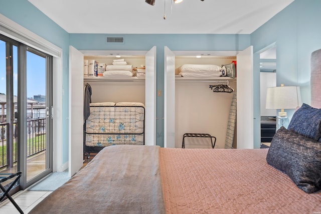 bedroom with access to outside, visible vents, and a closet