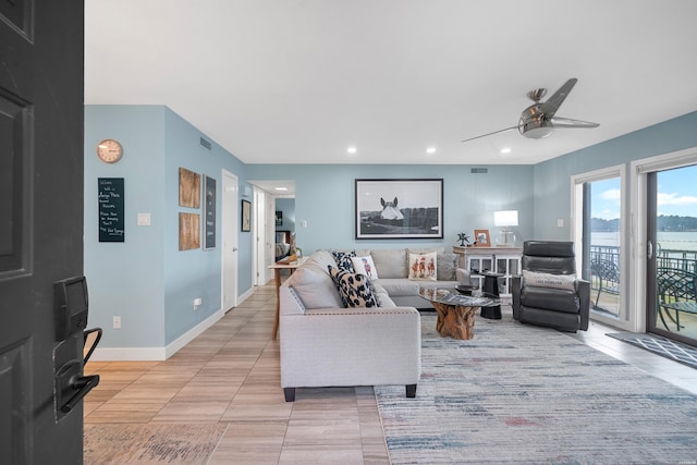 living room with ceiling fan, recessed lighting, light tile patterned flooring, and baseboards