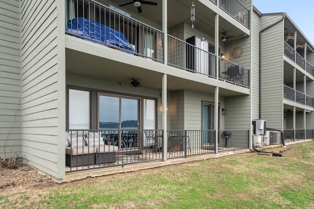 exterior space featuring a lawn, a ceiling fan, and central air condition unit