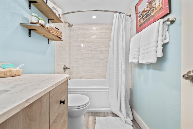 full bath with vanity, wood finished floors, toilet, and shower / tub combo with curtain