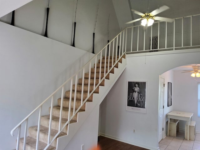 111 Prospect Ave Unit 10, Hot Springs, AR 71901 - stairway featuring baseboards, ceiling fan, a towering ceiling, wood finished floors, and arched walkways