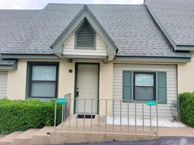 111 Prospect Ave Unit 10, Hot Springs, AR 71901 - view of exterior entry with brick siding and roof with shingles