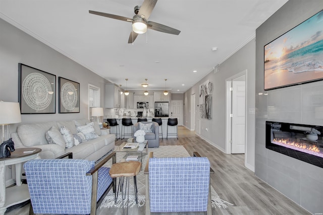 532 Grand Point Dr Unit C1, Hot Springs, AR 71901 - living room featuring crown molding, light wood finished floors, a fireplace, and a ceiling fan