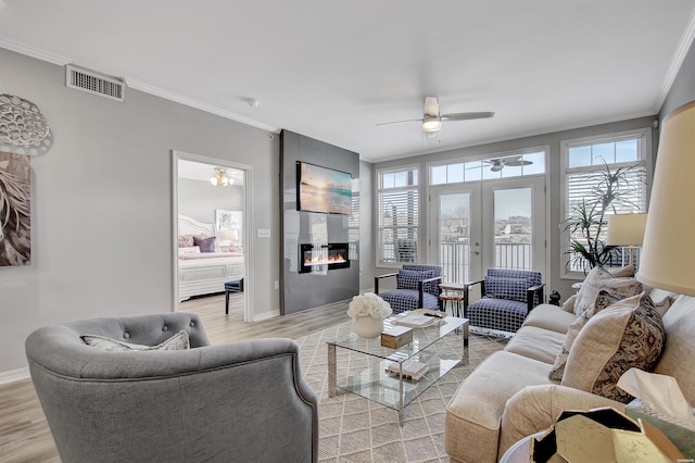 532 Grand Point Dr Unit C1, Hot Springs, AR 71901 - living area featuring ornamental molding, light wood-style flooring, visible vents, ceiling fan, and a tile fireplace