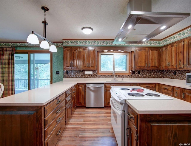 7 Sonora Way, Hot Springs Village, AR 71909 - kitchen with stainless steel appliances, island range hood, light countertops, light wood finished floors, and backsplash
