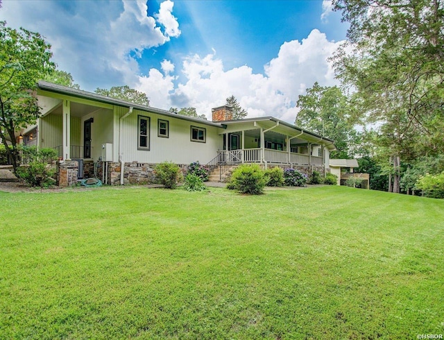 7 Sonora Way, Hot Springs Village, AR 71909 - rear view of house featuring a porch, a chimney, and a lawn
