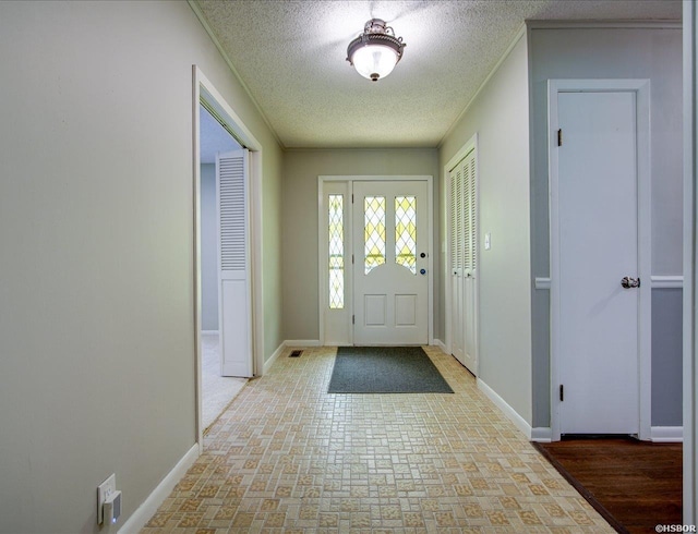7 Sonora Way, Hot Springs Village, AR 71909 - entryway featuring a textured ceiling, ornamental molding, and brick patterned flooring
