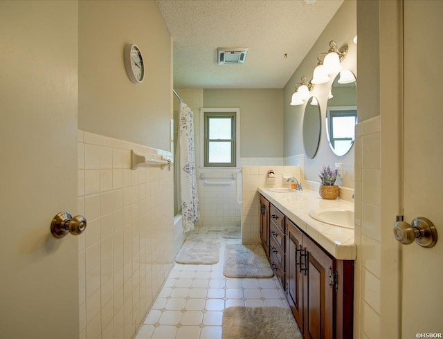 7 Sonora Way, Hot Springs Village, AR 71909 - full bath with tile walls, double vanity, a wainscoted wall, shower / tub combo, and a textured ceiling
