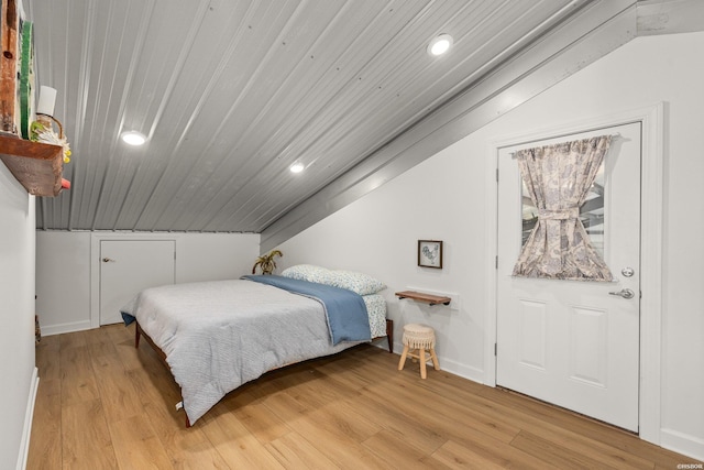 bedroom with baseboards, light wood-style flooring, recessed lighting, vaulted ceiling, and wooden ceiling