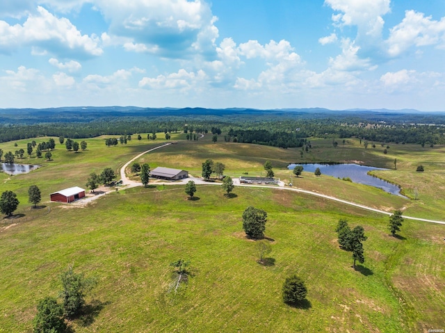 birds eye view of property with a water view and a rural view