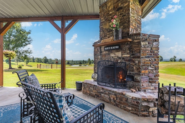 view of patio / terrace featuring an outdoor stone fireplace